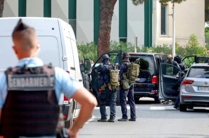 Law enforcement officers stand in front of a synagogue following the fire and explosion of cars in La Grande-Motte, France, on Saturday.Pascal Guyot / AFP via Getty Images